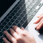 Quantum Computer - Close-up of Woman Holding a Laptop on Her Lap