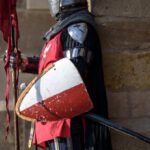 Security Shield - Man Wearing Gray and Red Armour Standing on the Streets