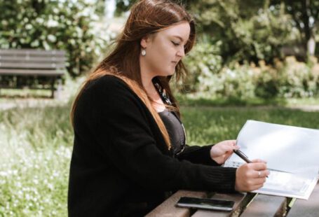 Data Size - Woman correcting information in paper with pen