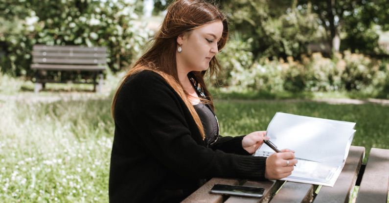 Data Size - Woman correcting information in paper with pen