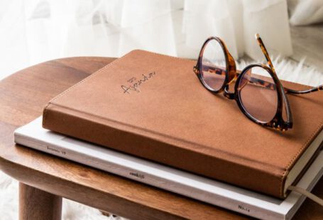 Calendar Update - Calendar and Glasses Lying on Little Wooden Table