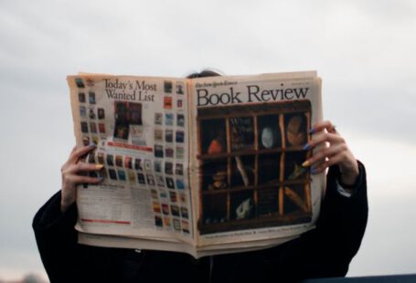 OS Update - Person Holding White and Brown Newspaper