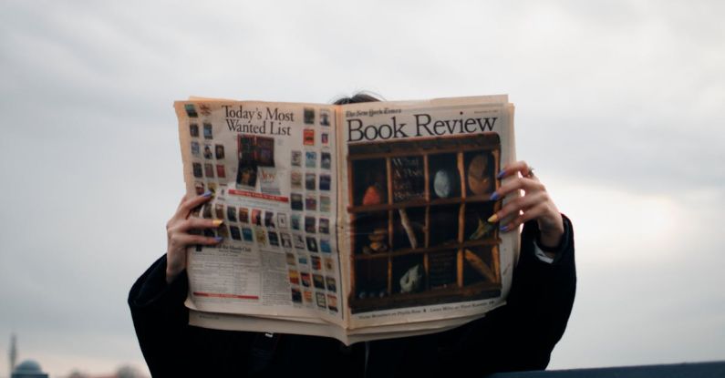 OS Update - Person Holding White and Brown Newspaper