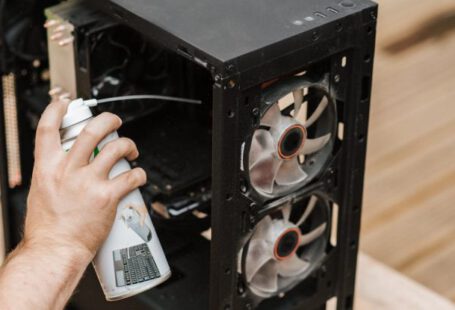 Compressed Air - Crop unrecognizable man cleaning computer system unit