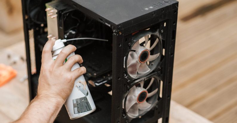 Compressed Air - Crop unrecognizable man cleaning computer system unit