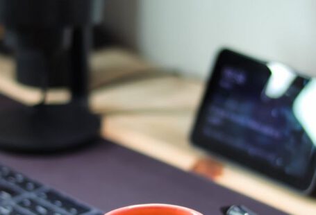 Computer Snail - A coffee cup sits on a desk next to a computer