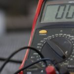 Multimeter - Professional multimeter with wires that combining functions of voltmeter ammeter ohmmeter placed on floor