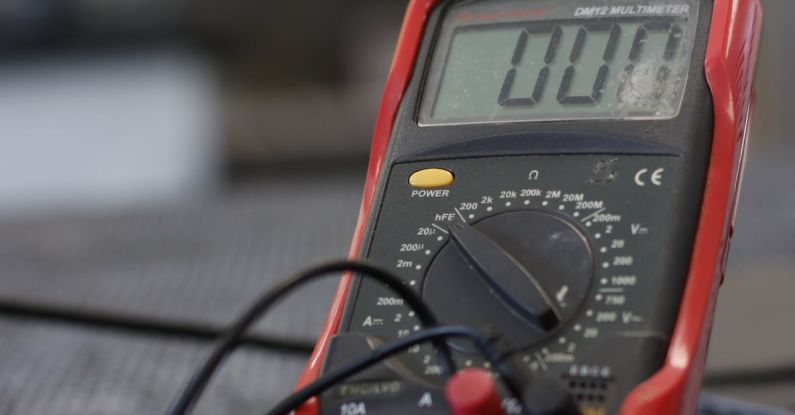 Multimeter - Professional multimeter with wires that combining functions of voltmeter ammeter ohmmeter placed on floor