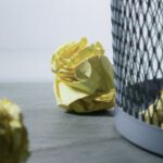 Recycle Bin - Focus Photo of Yellow Paper Near Trash Can