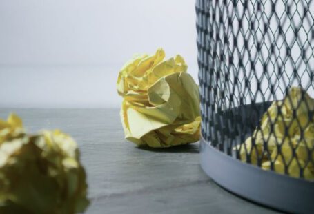 Recycle Bin - Focus Photo of Yellow Paper Near Trash Can