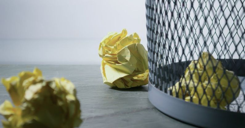 Recycle Bin - Focus Photo of Yellow Paper Near Trash Can