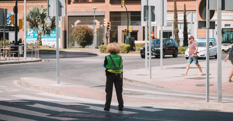 Troubleshooting Guide - A person standing on a street corner with a green jacket