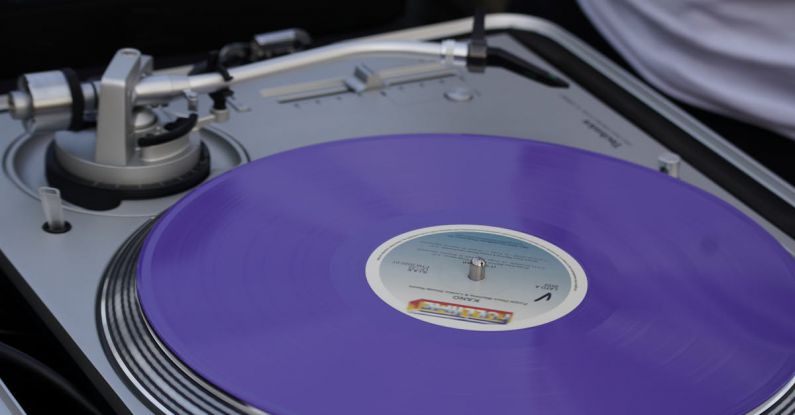 Disk Cleanup - A person is holding a purple vinyl record player