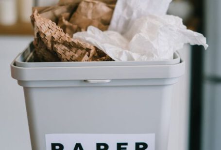 Tune-up Utilities - Closeup of plastic container full of paper placed on blurred background of kitchen in daytime