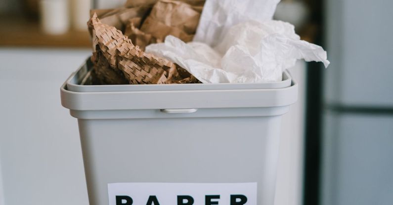 Tune-up Utilities - Closeup of plastic container full of paper placed on blurred background of kitchen in daytime