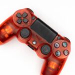 Gamepad Tool - Top view of modern orange gamepad for game console placed on white background
