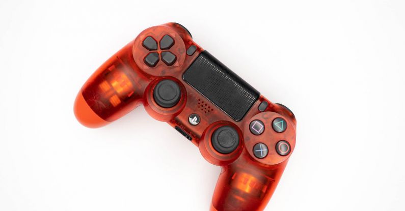 Gamepad Tool - Top view of modern orange gamepad for game console placed on white background
