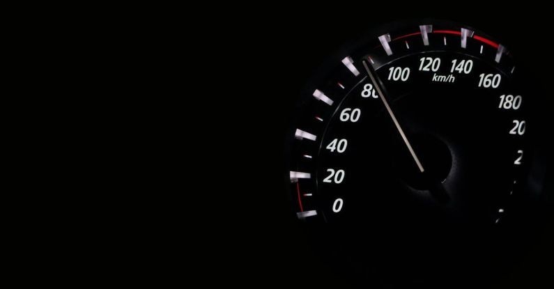 Speedometer - Close Up of Electric Lamp Against Black Background