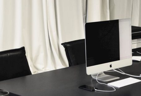 System Restore - Black and white of contemporary computer placed on table in simple contemporary workplace of office