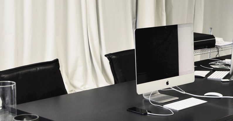 System Restore - Black and white of contemporary computer placed on table in simple contemporary workplace of office