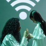 Wifi Signal - Woman in White Scrubs Connecting a Smartwatch of a Girl to Wifi