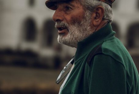 Profile Avatar - Profile of a Senior Man Wearing a Hat, against a Mosque